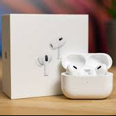 White wireless earbuds with charging case on a wooden surface, with a blurred background